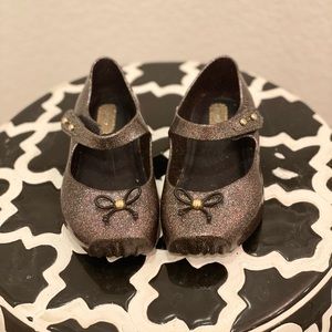 Little girl black and glitter Mini Melissa flats with cross strap shoes